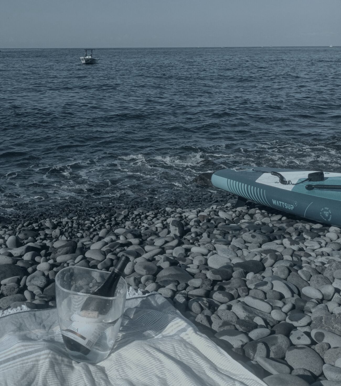 A paddleboard and chilled drinks on a quiet Madeira pebble beach